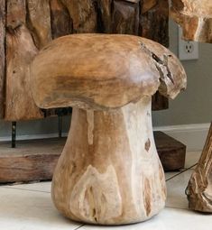 a wooden chair sitting on top of a white tile floor next to a tree stump