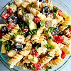 a bowl filled with pasta salad on top of a table