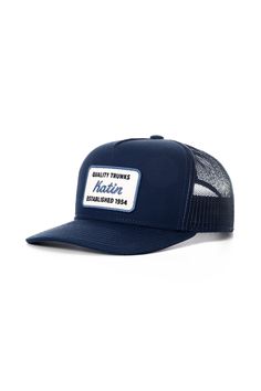 The Quality Trucker Hat features a custom patch reminiscent of license plates in Hawaii, the hat is made from cotton canvas with a polyester mesh back and snapback closure. Cotton canvas front, Polyester mesh back Katin embroidered patch 5-panel trucker hat Mid-crown structured fit Contrast stitch Snapback closure | Quality Trucker Hat Cotton in Indigo by Katin Cotton Trucker Hat 5-panel, Cotton Trucker Hat With Flat Bill, Navy Trucker Hat With Curved Bill, Cotton Trucker Snapback Hat With Logo Patch, Cotton Trucker Hat With Logo Patch, Cotton Trucker Snapback Hat, Cotton Trucker Hat With Flat Brim, Navy Trucker Snapback Hat With Curved Bill, Navy Curved Bill Hat With Logo Patch