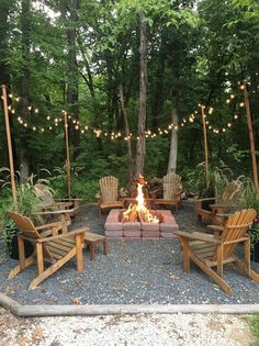 a fire pit surrounded by wooden chairs and lights