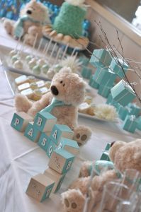 there are many teddy bears sitting on the table at this baby's first birthday party