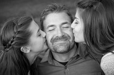 three women and one man are kissing each other with their noses close to the camera