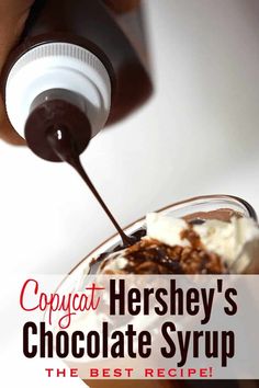 a person pouring chocolate syrup on top of a dessert in a glass bowl with the words copycat hershey's chocolate syrup