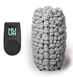 a large pile of rocks sitting next to a remote control on a white surface with the word hum written in green