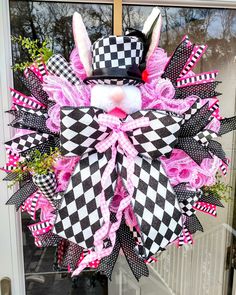 a pink and black easter bunny wreath on the front door