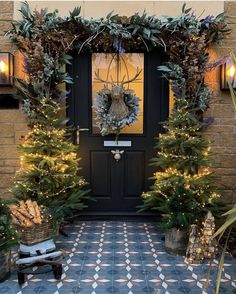 the front door is decorated with christmas trees and wreaths