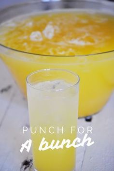 punch for a bunch in a glass next to an orange