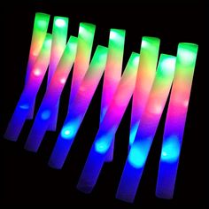 glow sticks are lined up against a black background