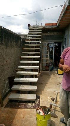 a man is standing in front of some stairs