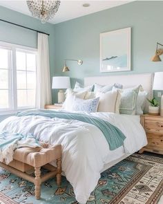 a bedroom with blue walls and white bedding