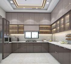 a modern kitchen with stainless steel appliances and marble counter tops, along with white flooring