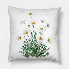 a white pillow with daisies and green leaves on the front, against a white background