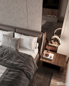 a bedroom with a bed, night stand and mirror on the wall next to it