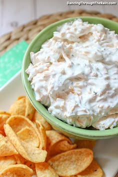 a bowl of dip and chips on a plate