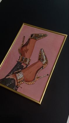 a painting of high heeled shoes on display in a gold framed frame with pink background