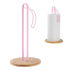 two pink and white toilet paper holders on wooden bases, one is holding a tissue dispenser