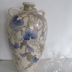 a white and blue vase sitting on top of a table