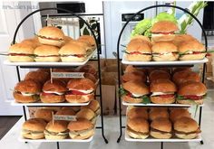 three tiered trays filled with sandwiches and rolls