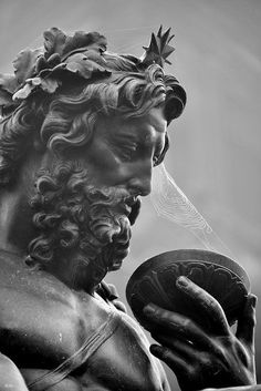 black and white photograph of a statue holding a frisbee