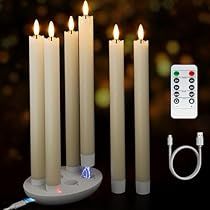 a group of candles with remote controls on a table