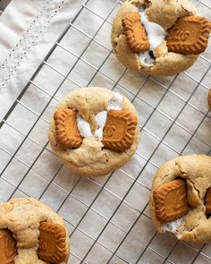 several cookies with white icing on a cooling rack