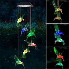 several different colored hummings are flying in the night sky, and there is also a wind chime