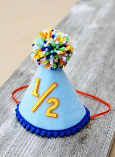 a blue birthday hat with the number twelve on it sitting on a piece of wood