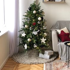 a decorated christmas tree in the corner of a living room