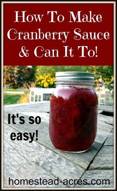 a jar filled with cranberry sauce sitting on top of a wooden table