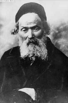 an old black and white photo of a man with a long beard wearing a hat