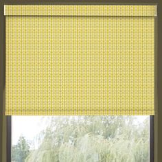 a window with yellow roman blind in front of it