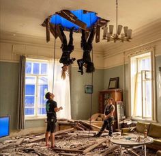 two people standing in a room that has fallen apart