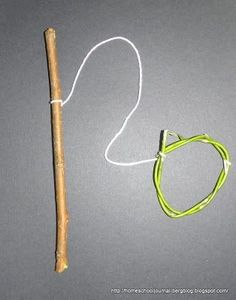 a wooden stick with a string attached to it next to a small piece of wood