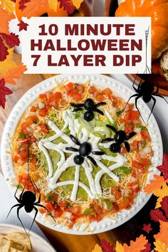 a white plate topped with lots of halloween food and spider decorations on top of it