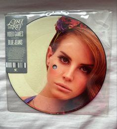 a cd cover with a woman's face and flower in her hair on it