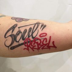 a man's arm with some writing on it and the words born to rosl written in red ink