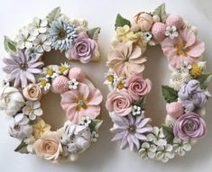 two wreaths made out of flowers sitting on top of a piece of white paper