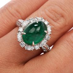 This exquisite GIA Natural Emerald & Diamond Cocktail Ring is expertly crafted in solid platinum with a total weight of 9.54 grams. The emerald with a weight of approx. 5.17 carats are surrounded by (6) round cut and (6) marquise cut genuine natural diamonds, (12) round-cut genuine natural diamonds placed on either side of the ring. All G-H color, and VS clarity forming a dazzling oval halo, The top of this piece measures 17 mm x 22 mm, 10 mm (height) currently US ring size 4.75 and sizable. Luxury Oval Emerald Birthstone Ring, Luxury Oval Platinum Gemstones, Oval Emerald Gemstones With Halo Setting, Luxury Oval Emerald Gemstones, Exquisite Oval Platinum Gemstones, Luxury White Gold Oval Cabochon Emerald Ring, Luxury Green Oval Gemstones, Formal White Gold Emerald Ring With Oval Cabochon, Green Oval Emerald Ring In Platinum