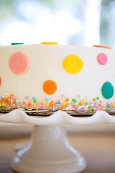 a white cake with multicolored polka dots on it