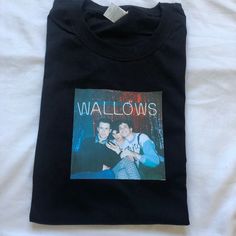 Wallows band custom tee printed by me! This print is printed onto quality fruit of the loom white T-shirt's and is available in sizes Small Medium Large and Extra large. I also do custom tees so feel free to message��😚 Unisex Crew Neck T-shirt With Heat Transfer Vinyl, Band Merch Cotton T-shirt With Custom Print, Custom Print Cotton T-shirt Band Merch, Black Pop Culture T-shirt With Custom Print, 90s Style Black T-shirt With Custom Print, Black Custom Print 90s T-shirt, Black T-shirt With Heat Transfer Vinyl Band Merch, Unisex Custom Print Band Merch T-shirt, Custom Print Fan Merchandise T-shirt