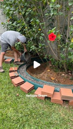 a man is working in the garden with bricks