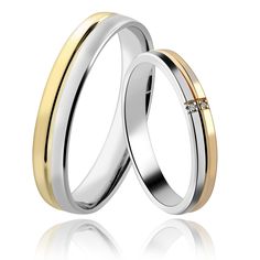 two gold and silver wedding rings with one diamond in the middle, on a white background