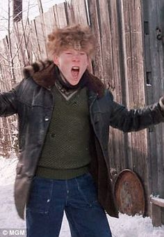 a man with his mouth open standing in the snow