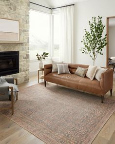 a living room filled with furniture and a fire place next to a large glass window