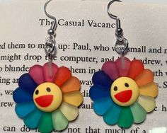 These cute earrings will add a pop of color and make a unique addition to you collection. Earring clip-ons are also an option! :) Please message if quantity of ear wire and clip ons are different. Happy Rainbow Flower Earrings, Quirky Handmade Multicolor Earrings, Quirky Multicolor Handmade Earrings, Novelty Multicolor Earrings With Ear Wire, Colorful Whimsical Earrings For Gifts, Whimsical Colorful Earrings For Gifts, Whimsical Earrings As A Gift, Adjustable Multicolor Earrings With Flower Charm, Adjustable Multicolor Flower Charm Earrings