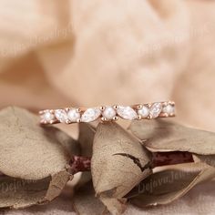 Delicate Pearl and Moissanite Wedding Band: A vintage-inspired, dainty ring featuring alternating pearls and marquise-shaped moissanite stones set in rose gold. This elegant wedding band or promise ring showcases a cluster of marquise diamonds in an art deco design, making it a beautiful and thoughtful gift for women who appreciate timeless, sophisticated jewelry. ✦ Handmade, high-quality item ✦ Material: SOLID 10K/14K/18K GOLD ( can be made in yellow/white/rose gold ) ✦ Stone: Moissanite & Fres Anniversary Pearl Ring In Rose Gold, 14k, Gold Wedding Bands Women, Sophisticated Jewelry, Pearl Rose, Vintage Inspired Rings, Rose Gold Wedding Bands, Ring Vintage, Marquise Diamond, Moissanite Wedding Bands