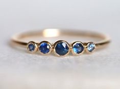 Blue sapphire ring, Blue sapphire stacking ring, dainty ring, stacking ring, stackable ring, blue sapphire ring, Sapphire ringAvailable in 9k/14k/18k yellow, rose or white gold.Same design can be made also with other custom gemstones per request. Product details:- Solid gold- approx 2.5, 2, 1.5 mm sapphire round- Band size is 1.2mmRing size - US 3 to US 9 (for smaller or larger ring size, please contact)Please select your size at the drop down menu. Service Available- Customization Available wit Sapphire Stacking Rings, Blue Sapphire Stackable Rings For Promise, Adjustable Blue Sapphire Ring Fine Jewelry, Blue Bezel Set Stackable Rings Fine Jewelry, Blue Fine Jewelry Stackable Rings With Bezel Setting, Blue Stackable Rings For Anniversary, Anniversary Blue Gemstone Stackable Rings, Blue Round Band Jewelry Gift, Blue Sapphire Ring With Bezel Setting For Promise