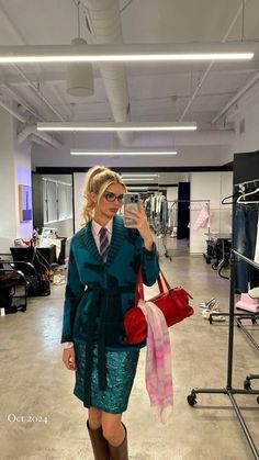 a woman is taking a selfie in an empty clothing store with her cell phone