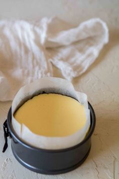 a bowl with some food in it sitting on a table next to a white towel