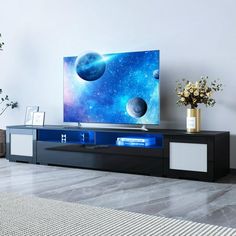 an entertainment center in a living room with a large television on it's stand